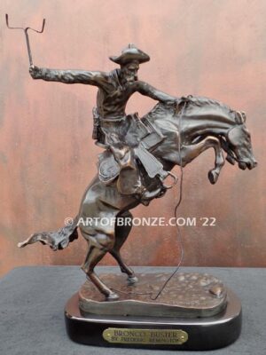 The Bronco Buster bronze sculpture after Frederic Remington featuring cowboy on horse