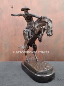 The Bronco Buster bronze sculpture after Frederic Remington featuring cowboy on horse