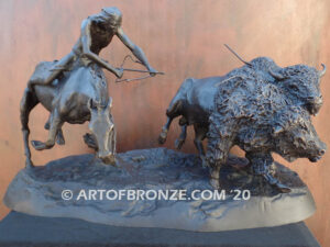 Buffalo Hunt bronze sculpture of Native American Indian on horse charging two bison.