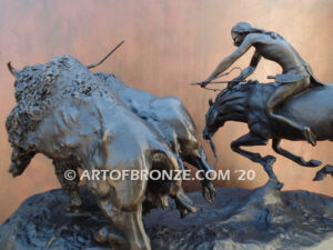 Buffalo Hunt bronze sculpture of Native American Indian on horse charging two bison.