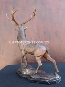 bull elk standing on rocky base design with head raised in bugling position bronze sculpture