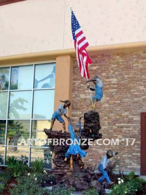 Celebrating Old Glory heroic bronze sculpture commission children holding flag climbing a rock