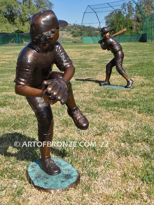 Championship Game bronze baseball player statues featuring a boy pitching and hitting
