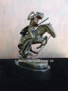 The Cheyenne bronze sculpture after Frederic Remington featuring warrior on galloping horse