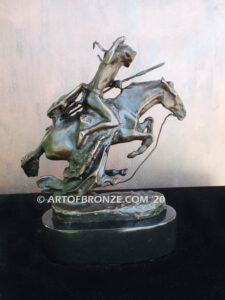 The Cheyenne bronze sculpture after Frederic Remington featuring warrior on galloping horse