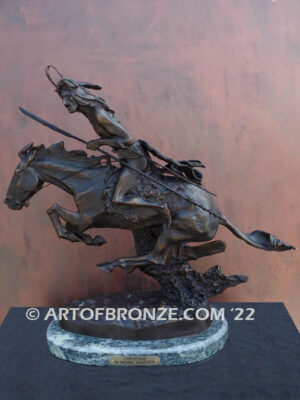The Cheyenne bronze statue after Frederic Remington featuring warrior on galloping horse