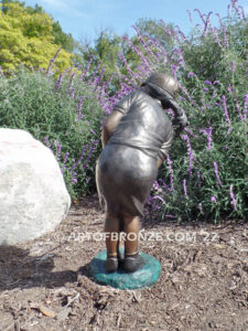 Chip Shot bronze statue of golfer girl chipping golf ball