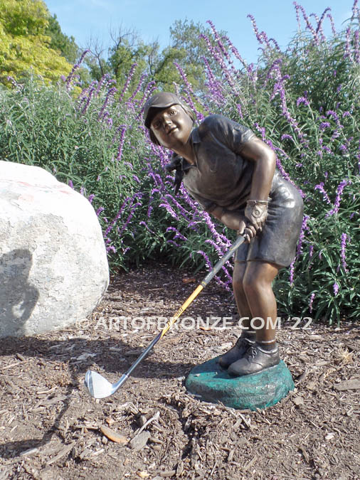 Chip Shot bronze statue of golfer girl chipping golf ball