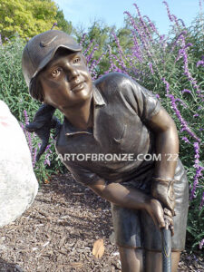 Chip Shot bronze statue of golfer girl chipping golf ball