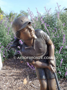 Chip Shot bronze statue of golfer girl chipping golf ball