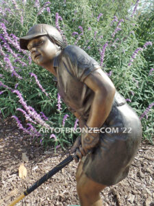 Chip Shot bronze statue of golfer girl chipping golf ball