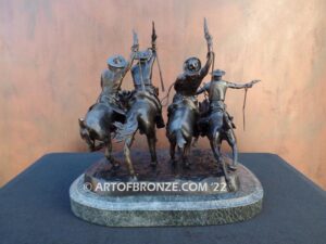Coming Thru the Rye bronze sculpture after Frederic Remington featuring four horseman on galloping horses