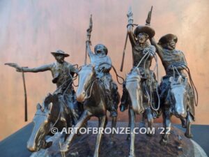 Coming Thru the Rye bronze sculpture after Frederic Remington featuring four horseman on galloping horses