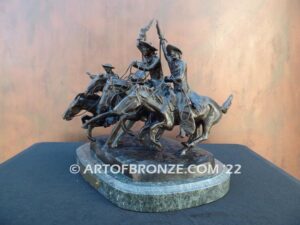 Coming Thru the Rye bronze sculpture after Frederic Remington featuring four horseman on galloping horses