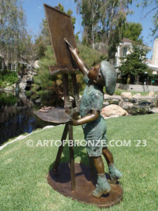 Creative Spirit painter boy bronze statue featuring boy painting canvas