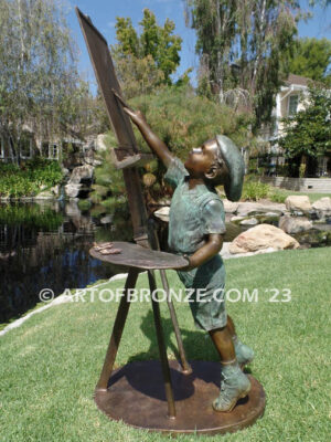 Creative Spirit painter boy bronze statue featuring boy painting canvas