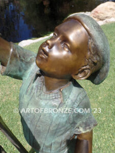 Creative Spirit painter boy bronze statue featuring boy painting canvas