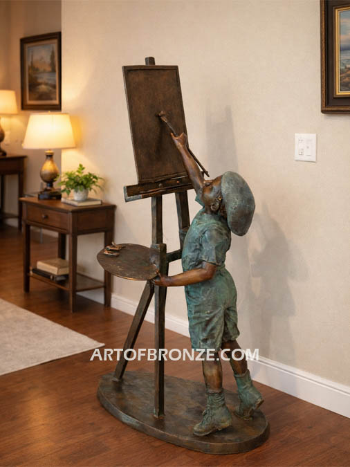 Creative Spirit boy painting bronze sculpture featuring boy painting canvas