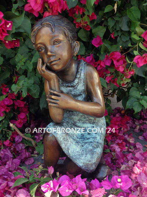 Cutie Pie bronze statue of girl relaxing in a daydream