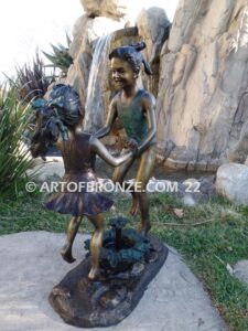 Dance Around bronze statue of girls in bathing suits dancing and jumping