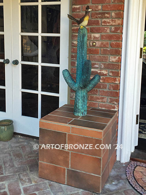 Desert Life (Roadrunner) life-size sculpture of a bronze cactus with a roadrunner on top of it