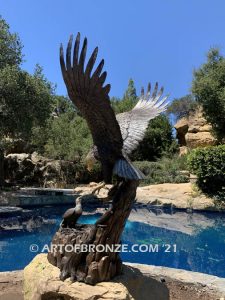 Dinner for Two statue of a life-size bald eagle feeding its baby eaglet in nest