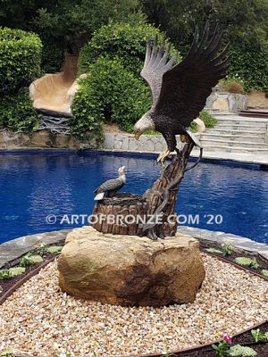 Dinner for Two statue of a life-size bald eagle feeding its baby eaglet in nest