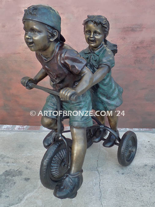 Endless Summer bronze sculpture of kids riding tricycle