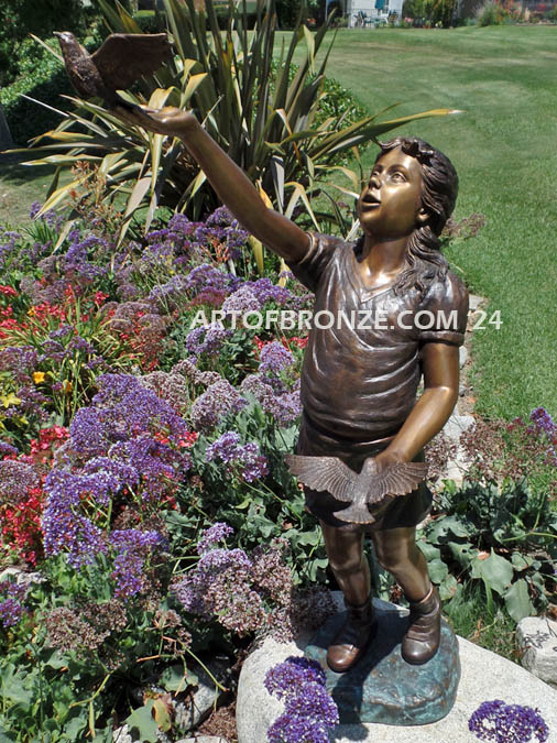 Faith and Hope bronze statue of young standing girl with doves in her hands