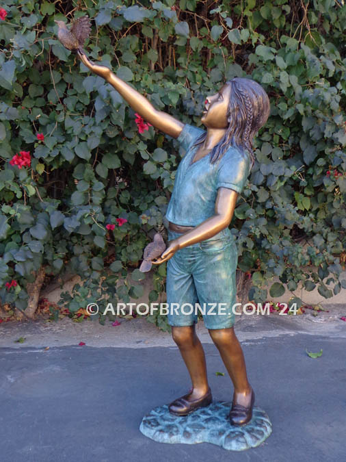 Faith bronze sculpture of young standing girl with doves in her hands