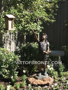 Faith and Hope bronze sculpture of girl letting go of doves