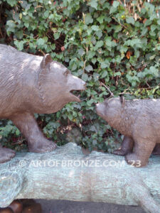 Family Business monumental outdoor bronze sculpture of mother and cub fishing for salmon