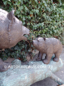 Family Business monumental outdoor bronze sculpture of mother and cub fishing for salmon