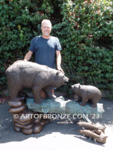 Family Business monumental outdoor bronze sculpture of mother and cub fishing for salmon