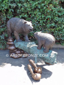 Family Business monumental outdoor bronze sculpture of mother and cub fishing for salmon