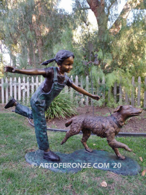 Friends for life outdoor garden bronze sculpture of young girl running with dog