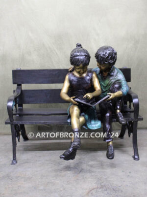 Friendship outdoor bronze garden sculpture of two children reading a book on bench