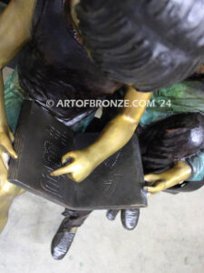 Friendship outdoor bronze garden sculpture of two children reading a book on bench