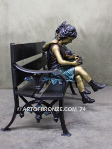 Friendship outdoor bronze garden sculpture of two children reading a book on bench