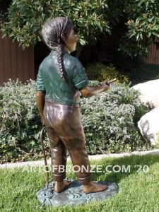 Garden Help outdoor bronze sculpture of standing girl with watering hose