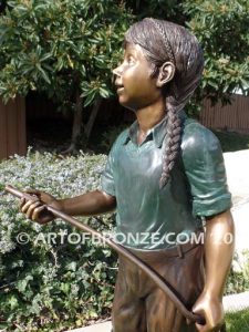 Garden Help bronze sculpture of standing girl with watering hose