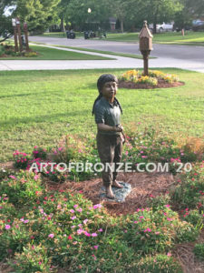 Garden Help outdoor bronze sculpture of standing girl with watering hose