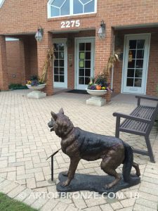 German Shepherd outdoor monumental bronze canine statue standing on alert with mouth open