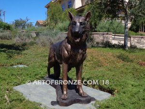 German Shepherd outdoor monumental bronze canine statue standing on alert with mouth open