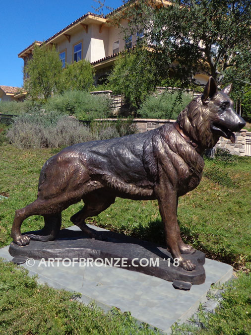 German Shepherd outdoor monumental bronze canine statue standing on alert with mouth open