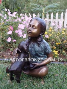 Give me Attention bronze sculpture of girl sitting with crossed legs dog on her lap