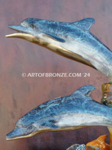Going Above two dolphins and sea turtle swimming along reef bronze sculpture