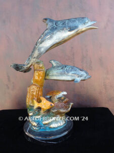 Going Above two dolphins and sea turtle swimming along reef bronze sculpture