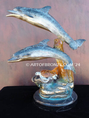 Going Above two dolphins and sea turtle swimming along reef bronze sculpture