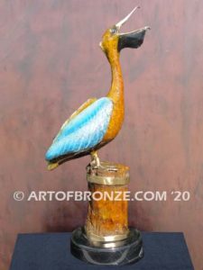 Bronze sculpture of playing pelican swallowing a fish